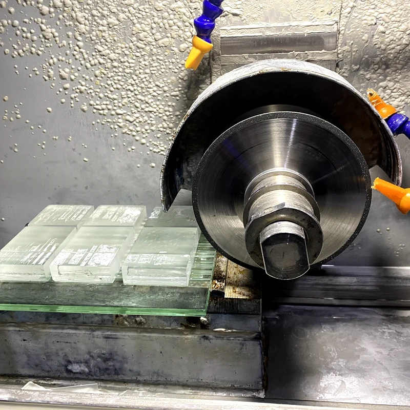Glass machining equipment at a cooperating optical component manufacturing facility